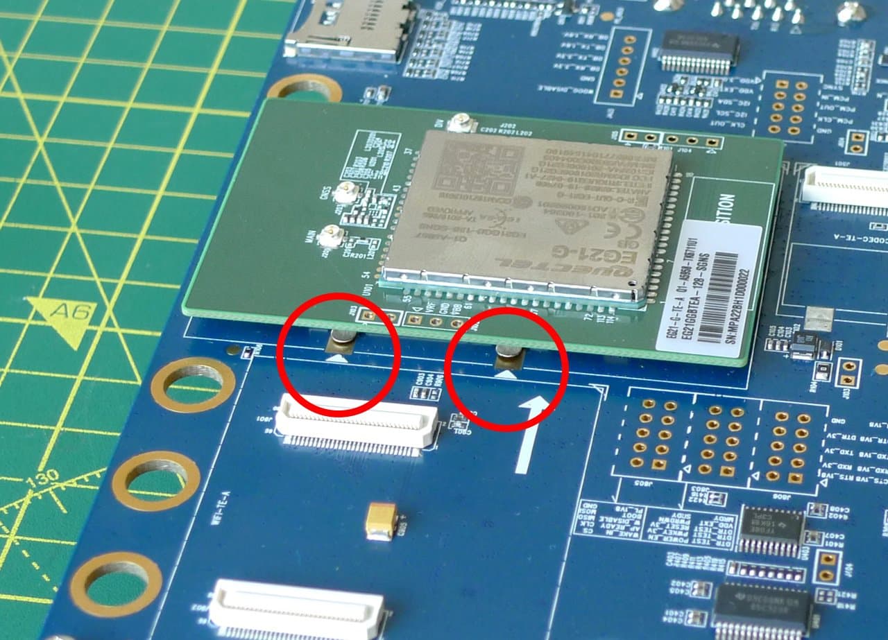 Align the test card's metal shield with the arrows printed on the EVB.