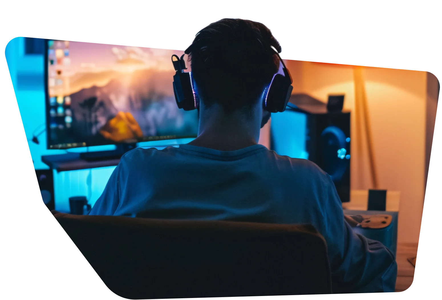 Person with headphones playing on a computer at a gaming setup, screen displaying a scenic background.
