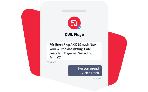 Two people reviewing marketing materials with an email campaign displayed on screen.