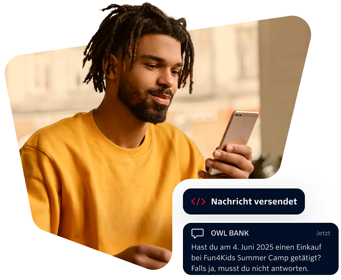 Young Man Receiving a Bank Message on Smartphone Man in yellow shirt looking at phone with a message from Owl Bank about a summer camp purchase.