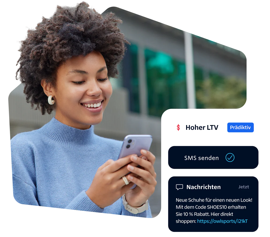 Smiling woman looking at her phone with SMS notification on screen.