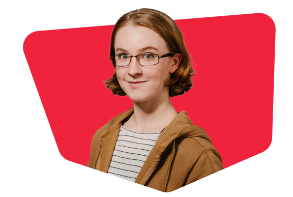 Person with glasses and short hair wearing a brown jacket and striped shirt on a red background