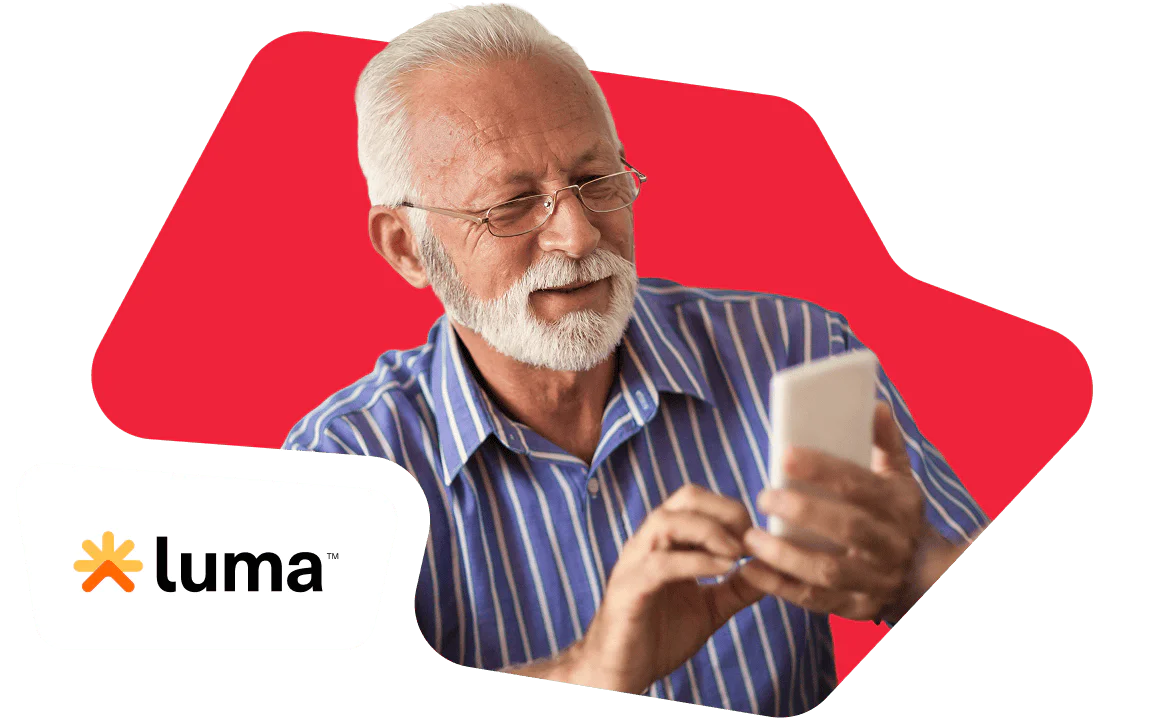 Elderly man in blue striped shirt using a smartphone with a red background and Luma logo.