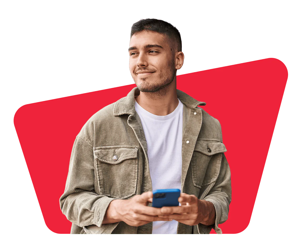 Woman in sunglasses and hat, wearing a brown jacket, smiling and posing with hands near face