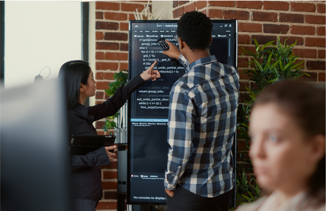 Colleagues reviewing Voice SDK on large screen