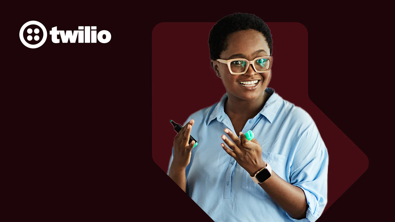 Woman holding a pen and explaining, wearing glasses, with Twilio logo in the background.
