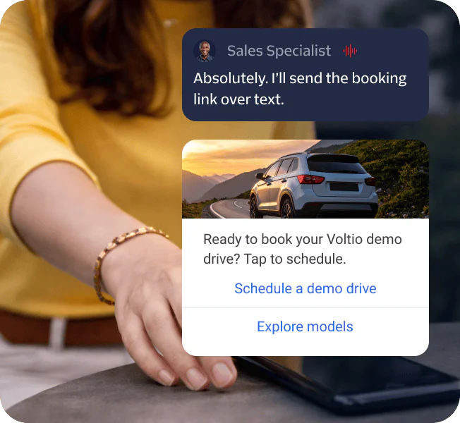 Person touching a phone with a booking link message and a car demo drive scheduling prompt.