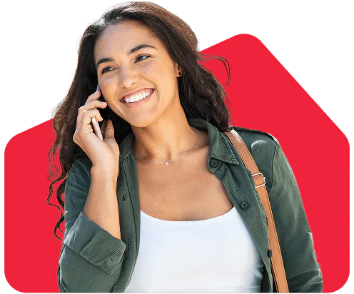 Woman with long hair smiling and talking on a phone.