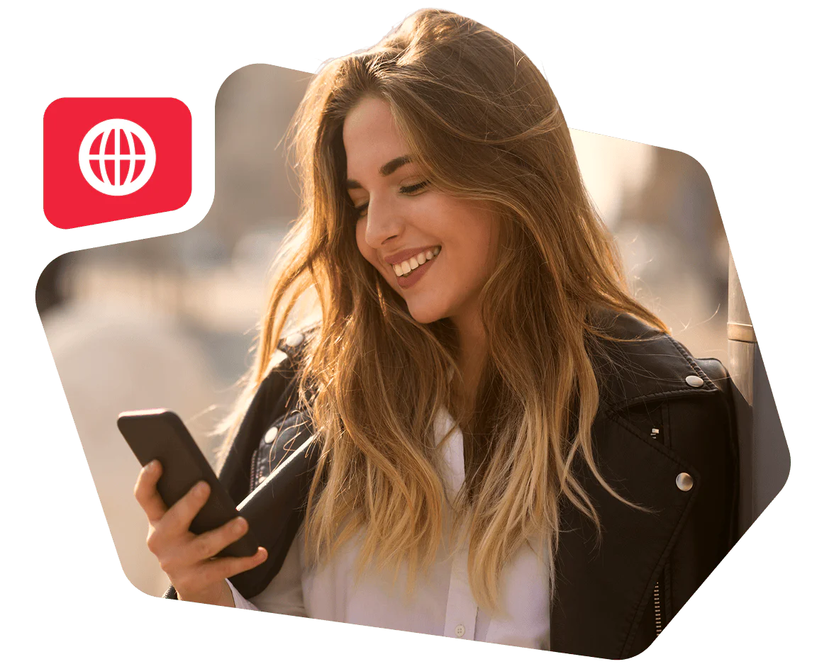 Smiling Woman Using Smartphone Outdoors Woman with long hair in leather jacket smiling while using a smartphone outside