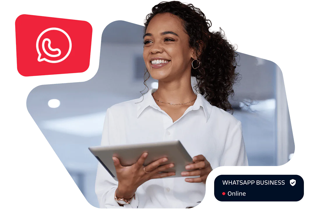 Woman in a white shirt smiles while holding a tablet with a WhatsApp icon in the background