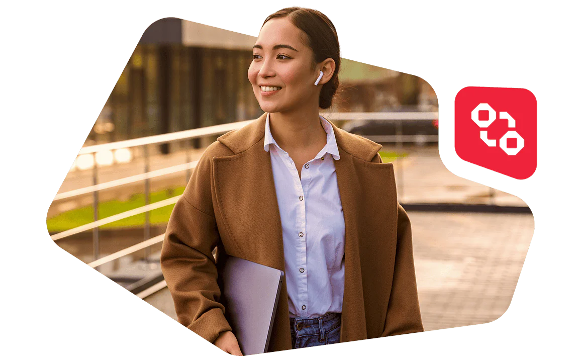 Businesswoman with Laptop and Earbuds Walking Outside Modern Building Woman in brown coat and white shirt walking outside with a laptop and wearing wireless earbuds.