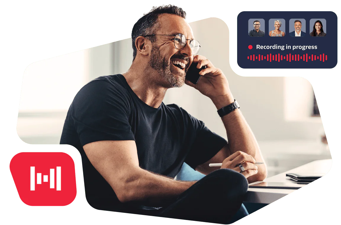 Man smiling while talking on phone with a computer displaying a recording in progress notice.