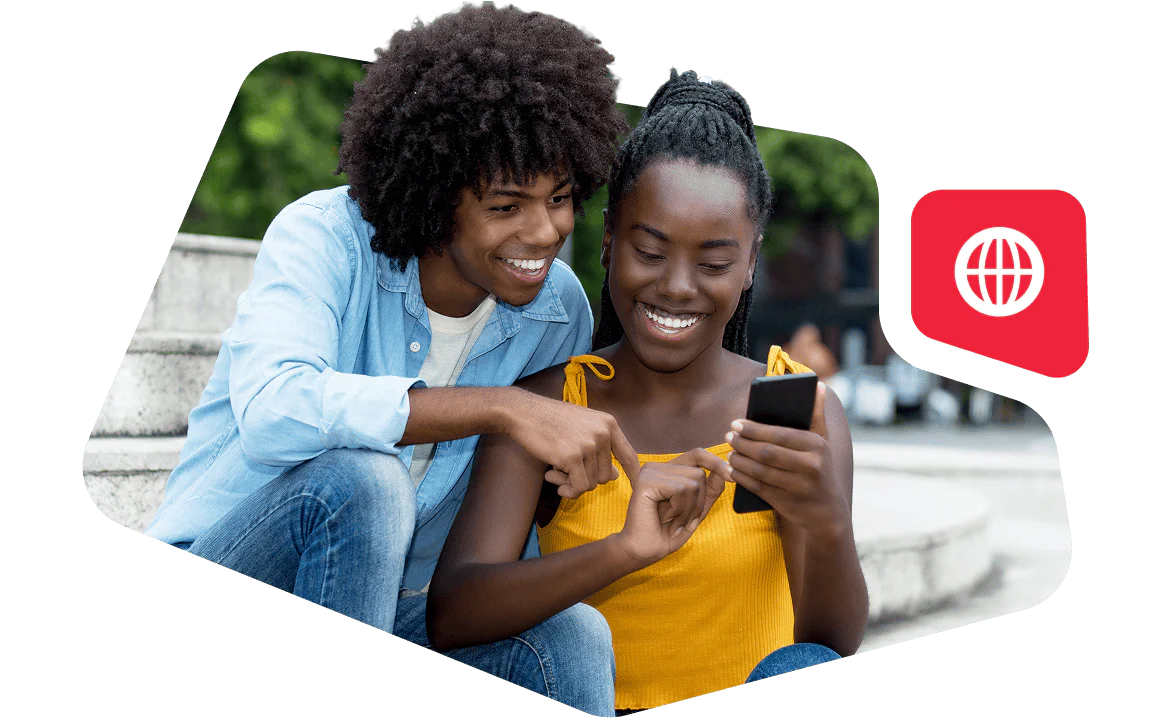 Couple Enjoying Time Together on Smartphone Smiling couple looking at a smartphone while sitting outdoors.