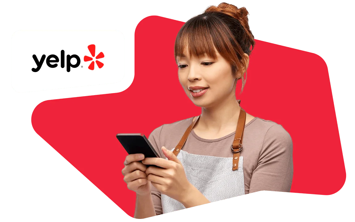 Woman Using Mobile Phone in Front of Yelp Logo Woman looking at her smartphone, wearing an apron, with the Yelp logo beside her against a red background.