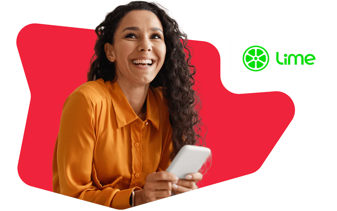 Woman Smiling and Holding a Smartphone with Lime Logo Smiling woman in an orange shirt holding a smartphone, with Lime logo in the background.