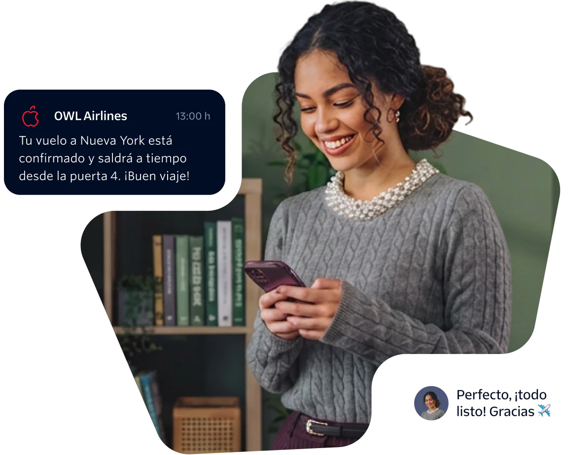 Woman smiling and looking at her phone while holding a flight confirmation message.
