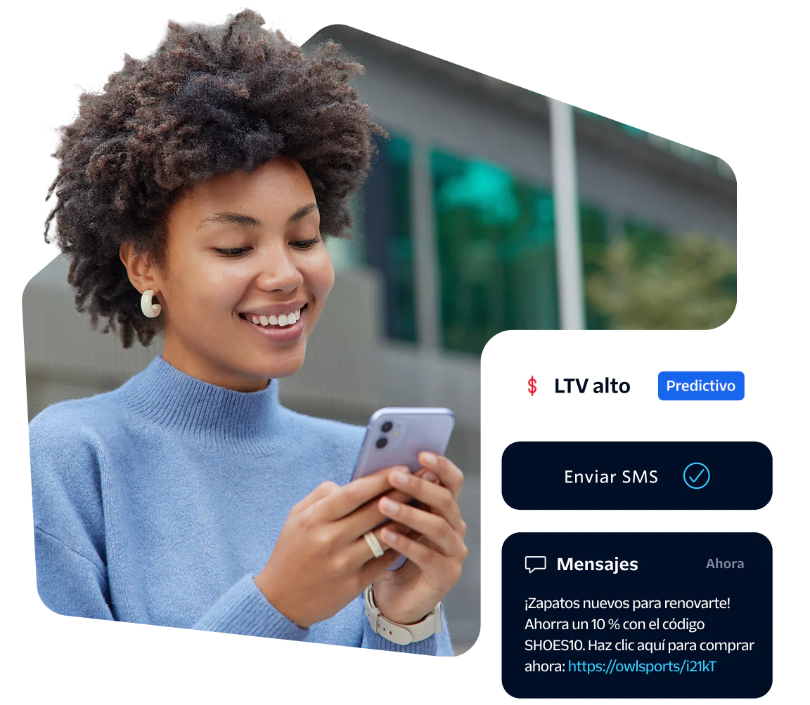 Smiling woman looking at her phone with SMS notification on screen.