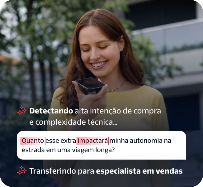Woman speaking into a smartphone held in her hand while standing outside.