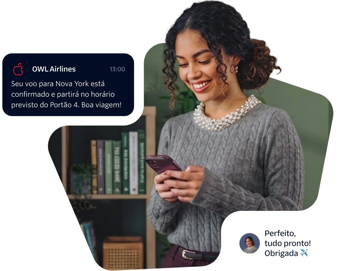Woman smiling and looking at her phone while holding a flight confirmation message.