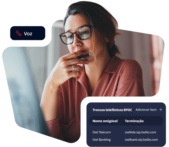 Woman in glasses looks intently at monitor, viewing telecommunications trunk terminations on screen.