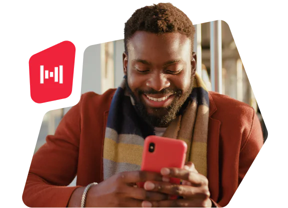 Smiling man wearing a colorful scarf uses a red smartphone with a red icon overlay on the left.