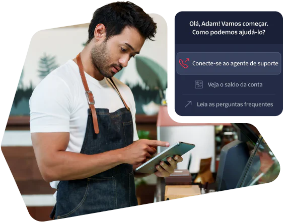 A barista in an apron using a tablet with a customer support prompt displayed on the screen.