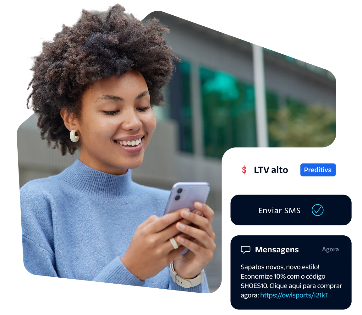 Smiling woman looking at her phone with SMS notification on screen.